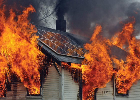 Photo of burning house with solar panels on roof